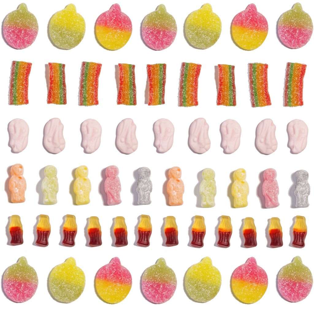 Assorted colourful sweets, including cola bottles, sour apples, and jelly babies, on a white background
