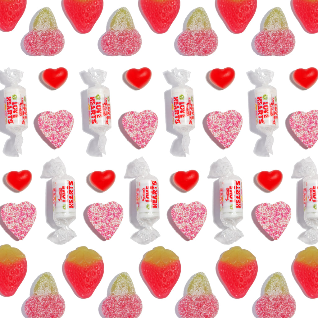 Assorted colourful gummy sweets, candies and sour treats on a white background.
