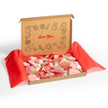 Gift box of assorted sweets and candies with a decorative lid inscribed with a sign, set against a white background.
