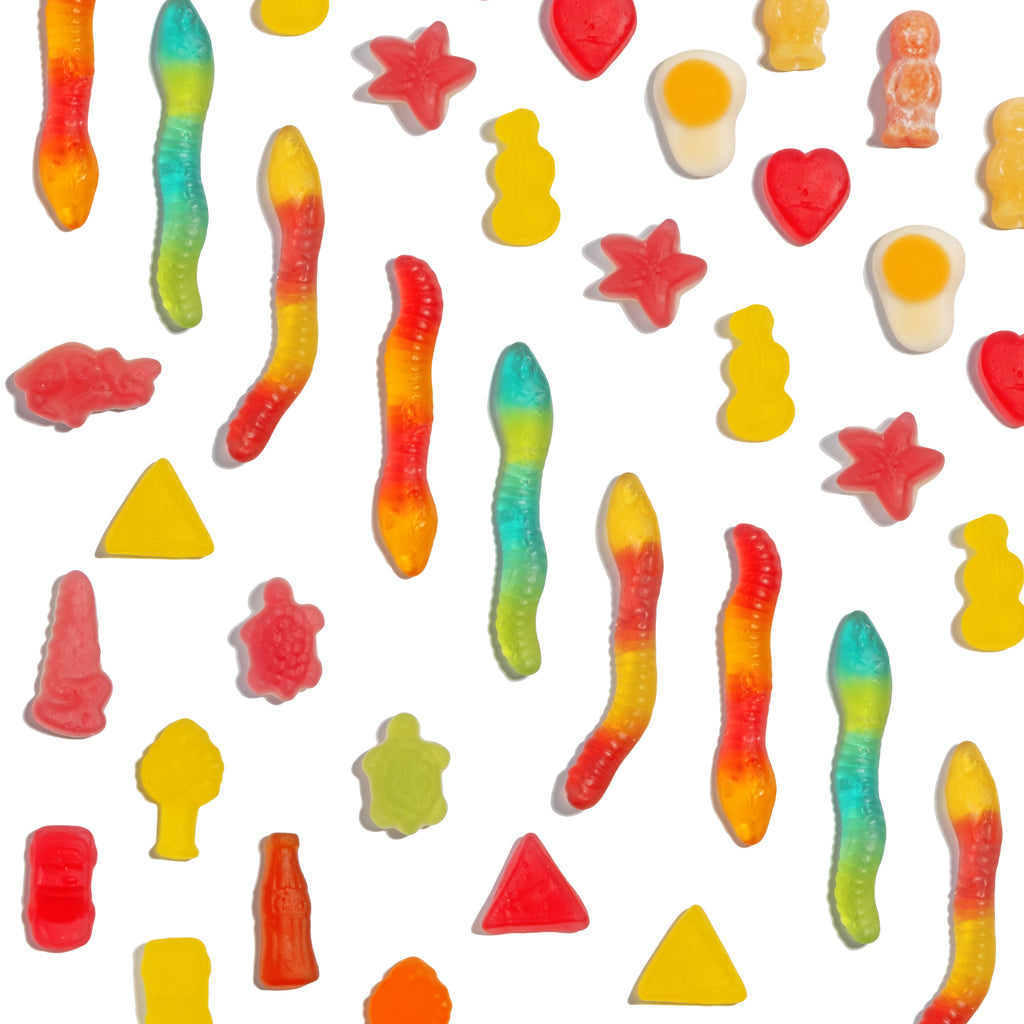 Assorted colourful gummy jelly sweets on a white background.
