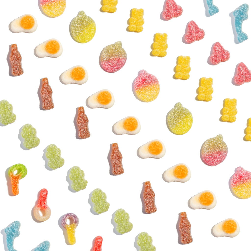 Assorted colourful sour sweets on a white background.

